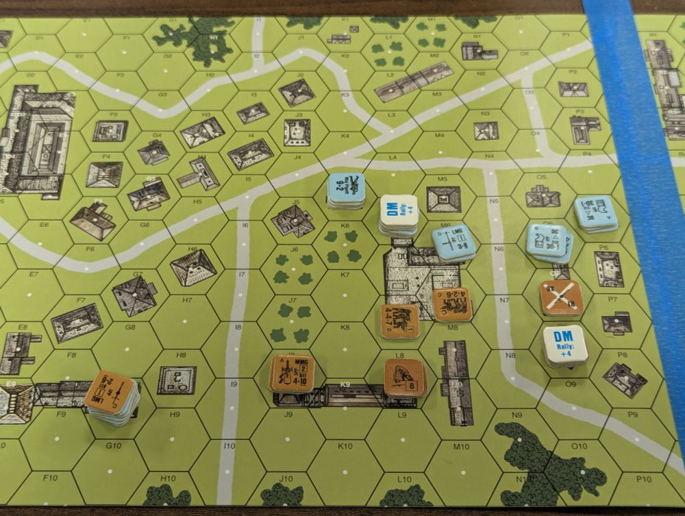 Cardboard pieces representing small units of WWII era Soviet and German infantry do battle on a hex grid representing urban terrain.  The Germans appear to be doing well for themselves.