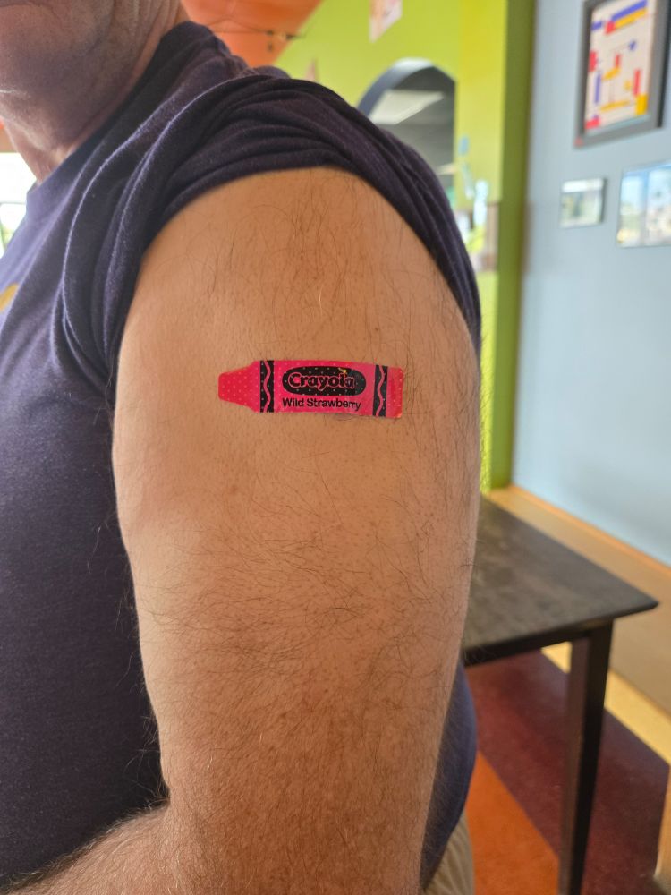 Picture of bandage on my arm after receiving vaccine.