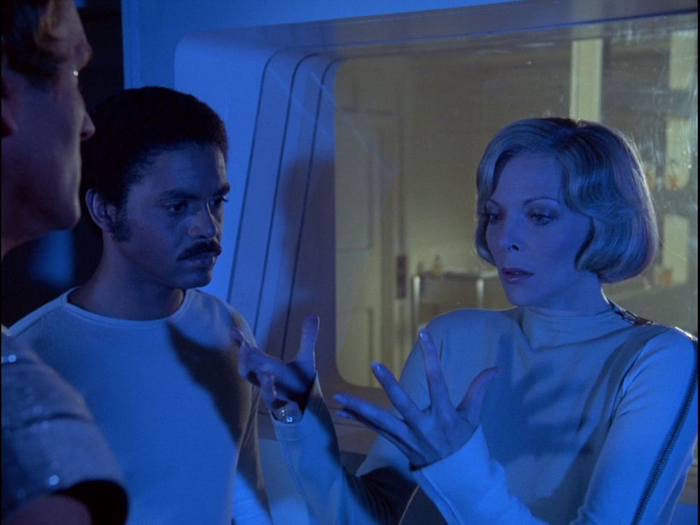 Dr. Russell examining her hands with concern (Space: 1999) 