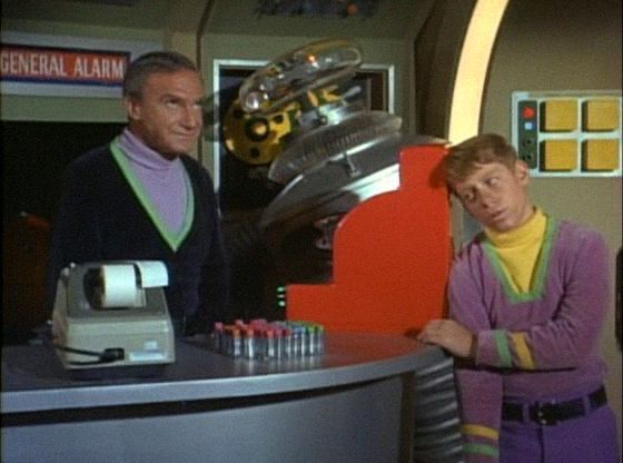 Dr. Smith, Will and the Robot next to a till (and adding machine) that was inexplicably available to them while being Lost in Space 