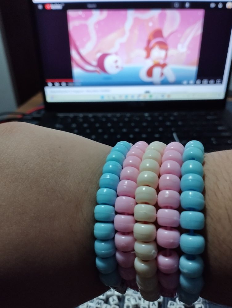 the transgender flag as a kandi bracelet around my wrist (outer arm)