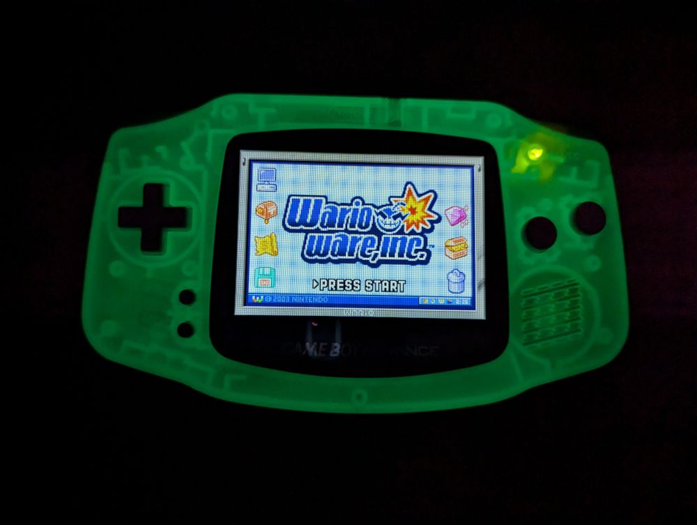 Glow in the dark gameboy advance showing the game WarioWare Inc