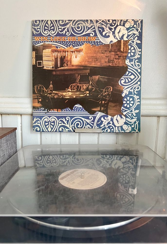 Turntable playing the Allman Brothers album Win, Lose or Draw with the album cover displayed above. 