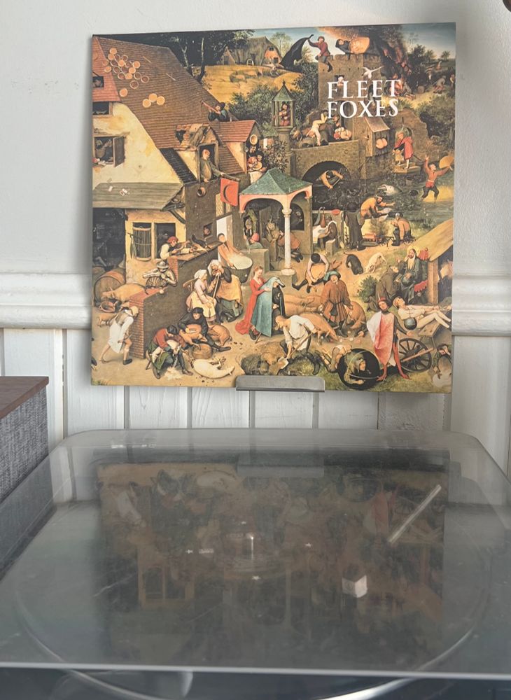 Turntable spinning Fleet Foxes 2008 self-titled album with the album cover displayed above. 