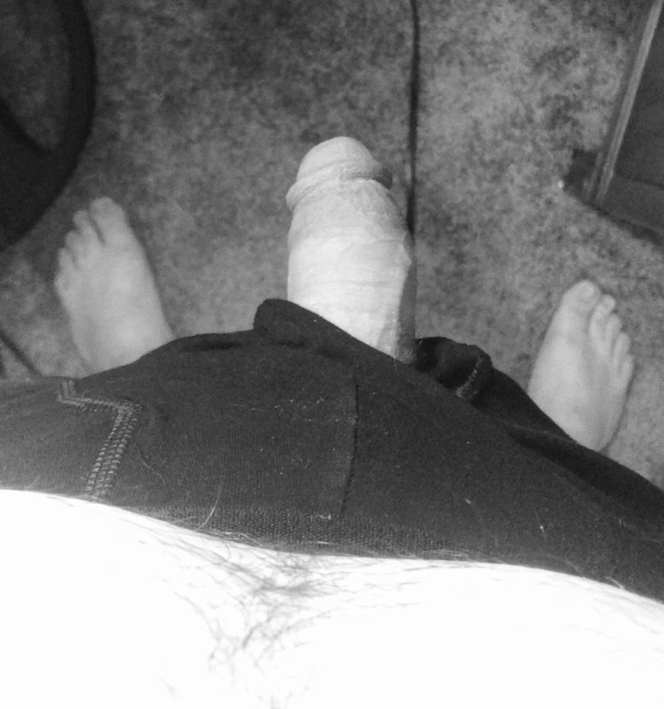 Black and white photo looking down at my soft dick hanging out of my underwear