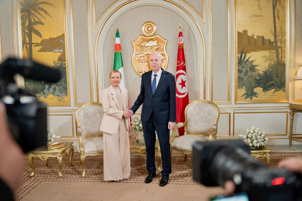 President of the Council of Ministers of Italy, Giorgia Meloni, meets Kais Saied, President of the Republic of Tunisia. She is wearing a beige suit with enormous flappy trousers, he looks like an elderly version of Joe Biden crammed into the standard black businesswear of governance.