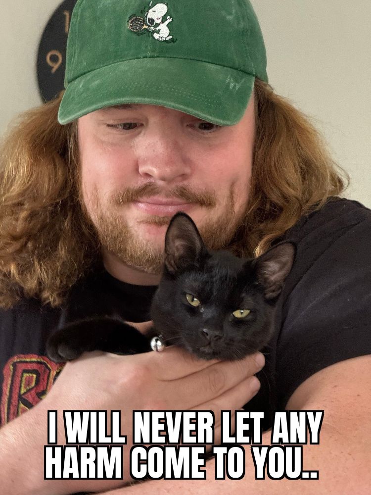 @yogabapentin.bsky.social with his awesome cat, with the caption "I will never let any harm come to you..."