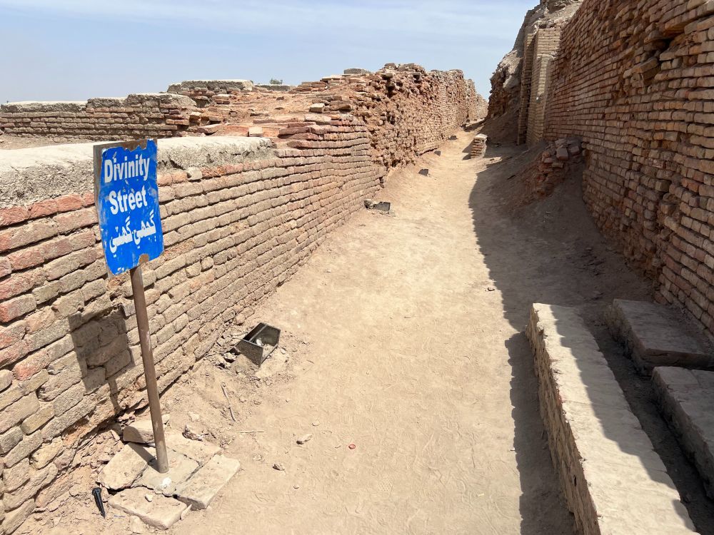 Ruined street made of red brick with approx 5 - 10 foot high walls