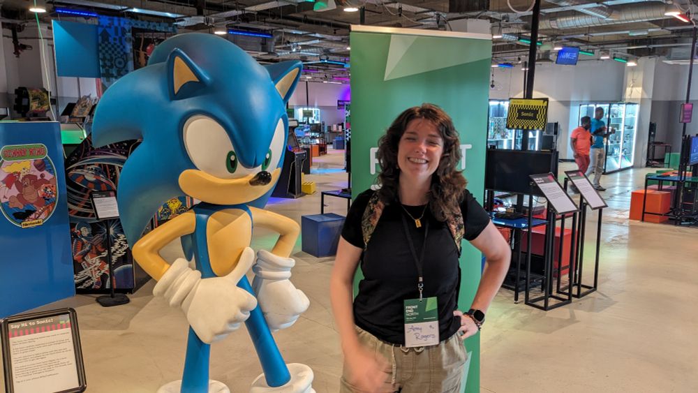 Me standing next to Sonic the Hedgehog. He looks cool but my eyes are closed.