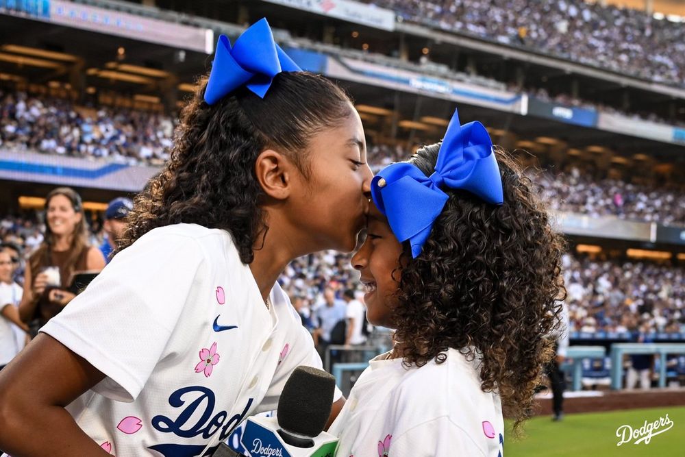 Bianka Bryant kisses Capri Bryant on the forehead after doing “It’s Time for Dodger Baseball.”
