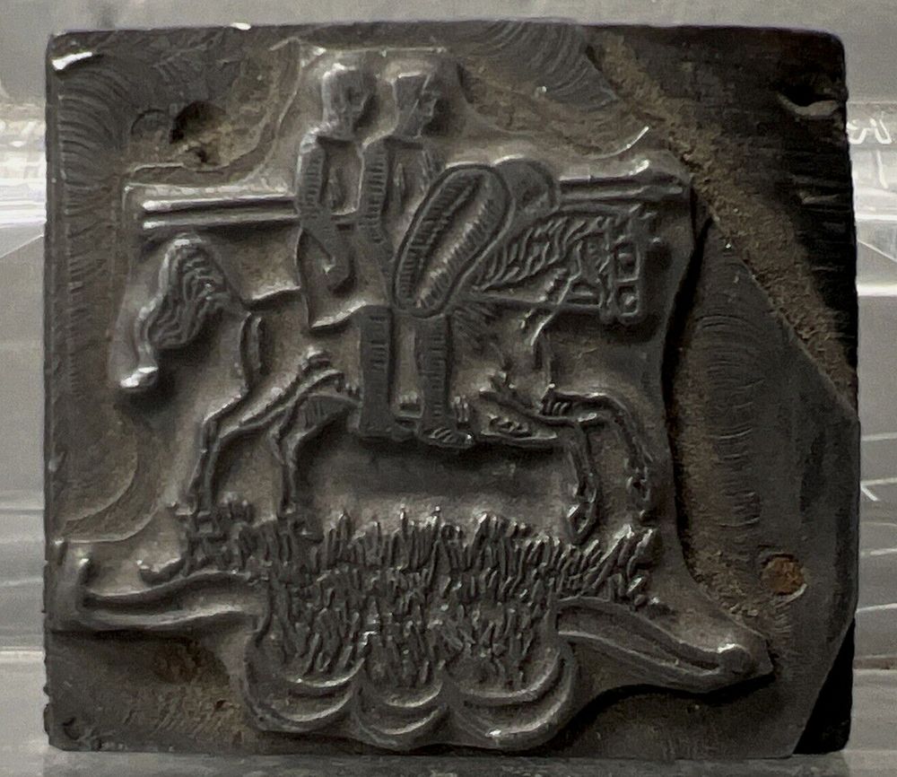 Historical letterpress block showing an illustration of two armored knights riding on one horse