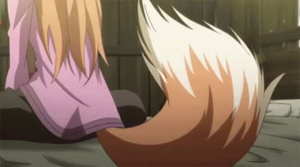 a fox tail is being held by a girl