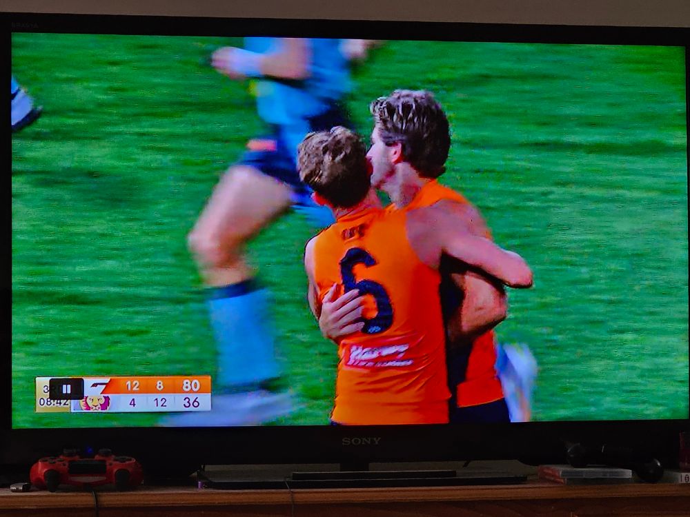 Two GWS players hug after kicking a goal to put them 44 points up over the Lions with 8:42 remaining in the 3rd quarter of the First Semi Final.