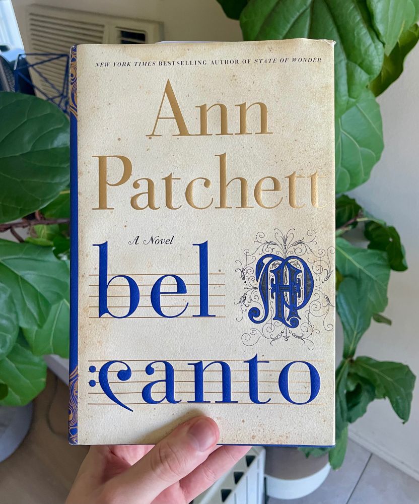 Me holding a copy of Bel Canto by Ann Patchett