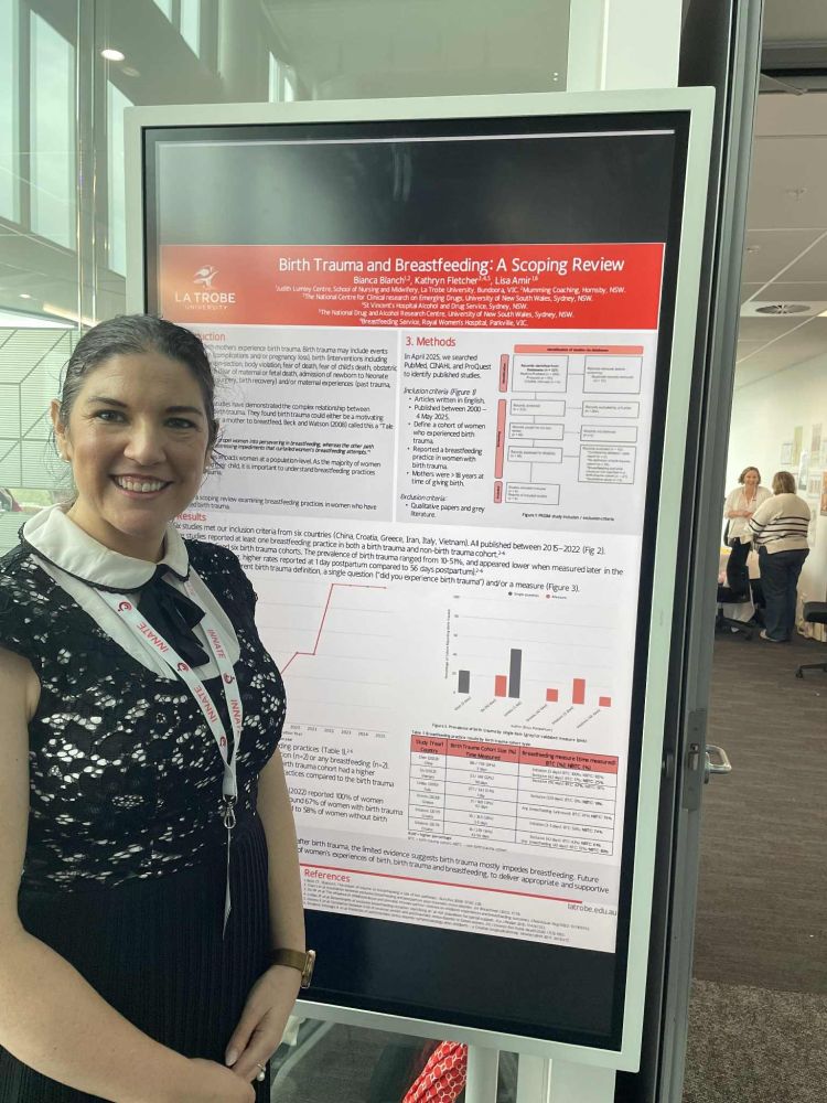 Woman standing in front of a conference poster