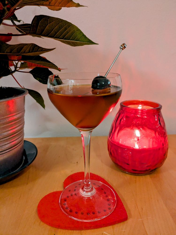 A Bijou cocktail served in a Nick & Nora glass