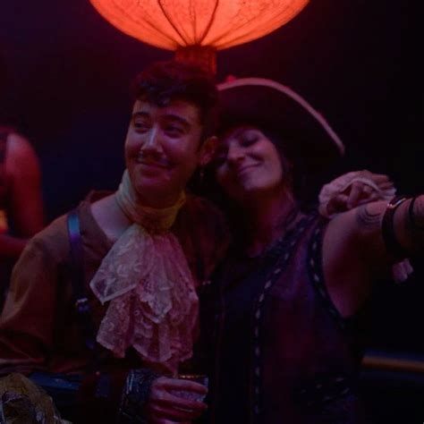 Jim Jimenez with their arm around their girlfriend Archie at Calypso's Birthday in season 2 of Our Flag Means Death