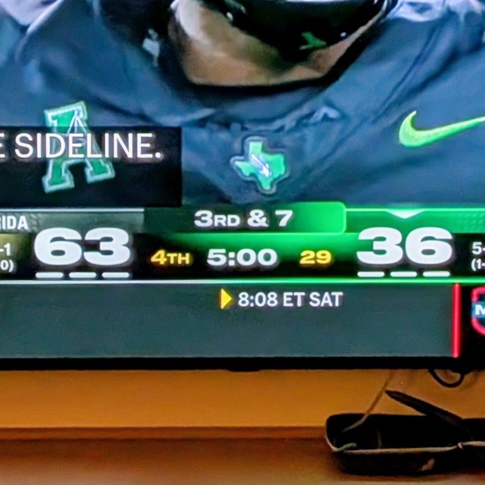 Photo of broadcast graphic displaying the score in the USF vs. UNT game, which USF is winning 63-36