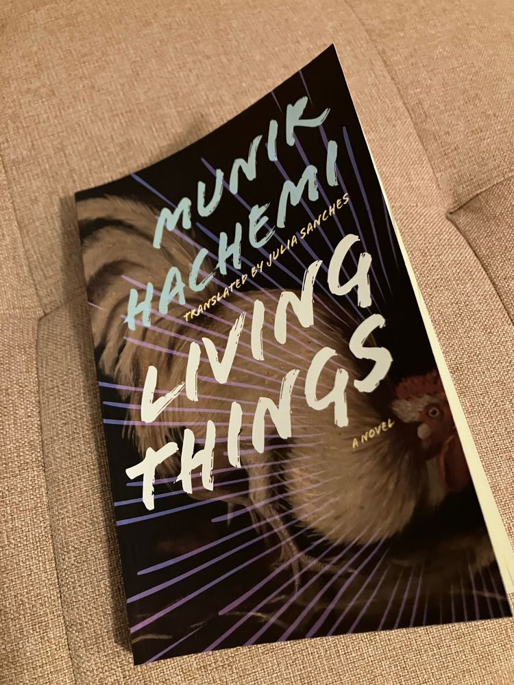 A picture of Munir Hachemi’s Living Things, a novel with a crazed chicken on the cover 