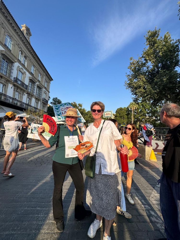 Mariëlle and Barbara smiling to the camera on the streets, during the march