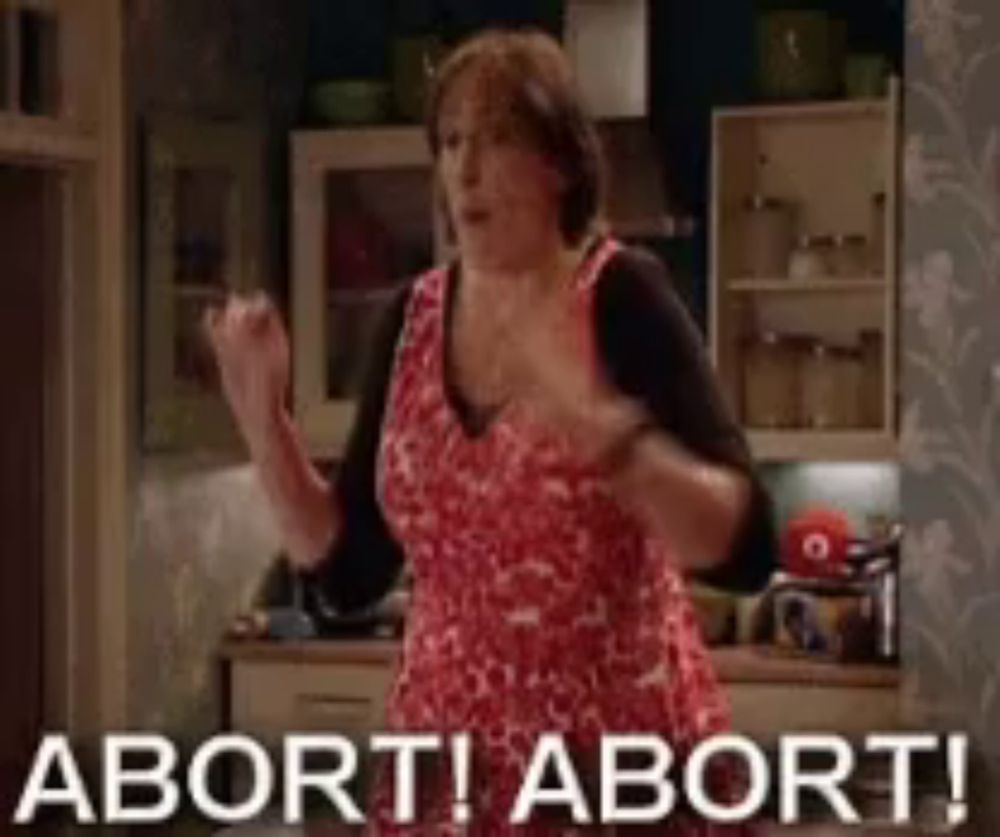 a woman in a red dress is dancing in a kitchen with the words abort ! abort ! written on the bottom