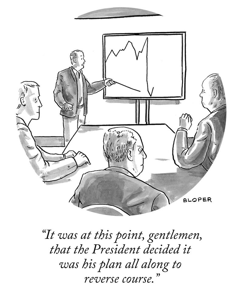 Man leading meeting stands at a chart pointing to the nadir of a huge drop in the stock market