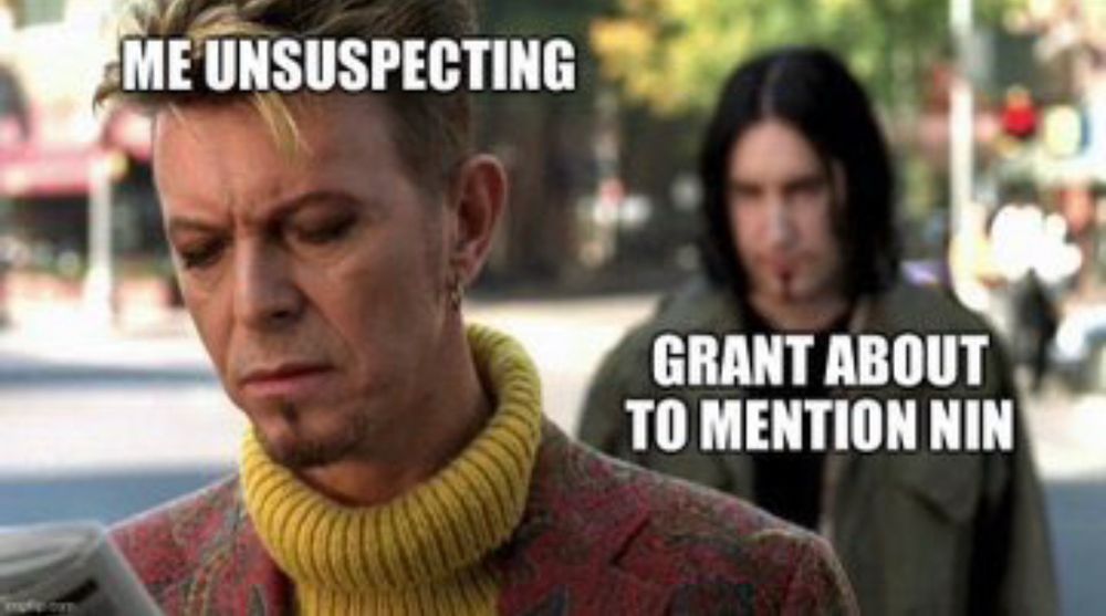 David Bowie, facing the camera, with the words “Me unsuspecting”, while in the background lurks Trent Reznor, with the words “Grant about to mention NIN”