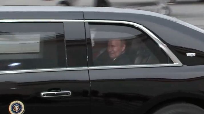 A smiling Putin and Trump travel together in a US limo