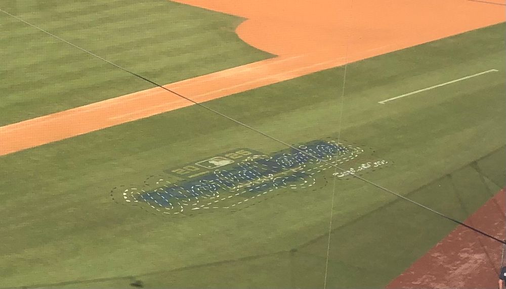 The outline for the World Series logo on the first base side of the field at Dodger Stadium in foul territory, just waiting to be fully painted.