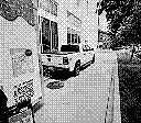 Game Boy Camera style grey scale picture of a truck pulling a trailer