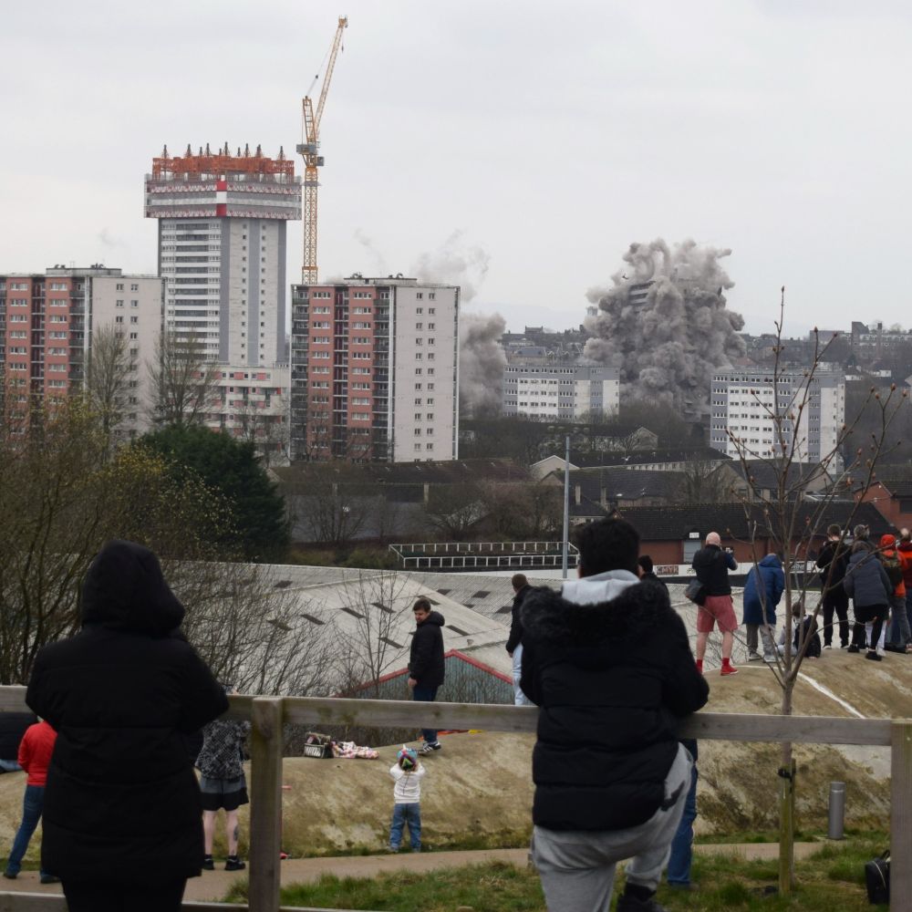 little sign remains of the destroyed blocks. The final block's destruction continues with it's levels beginning to bucle and lean to the left as chunks break away to join the cloud of debris.