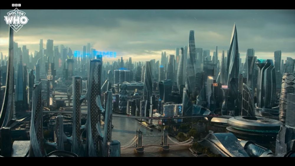 The London Skyline from above looking West with hundreds of supertall skyscrapers rising from every parcel of land. The shot is centred along the River Thames and Tower Bridge is featured looking low rise in comparison to all the tall buildings.

© BBC Doctor Who 2024