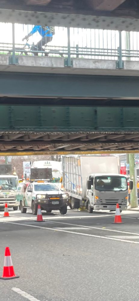 A truck stuck under the Montague Street Bridge