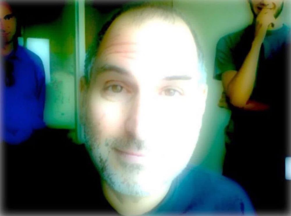 an image of steve jobs testing out a camera filter that makes his white boy skin glow like a lamp or perhaps even an angelic being