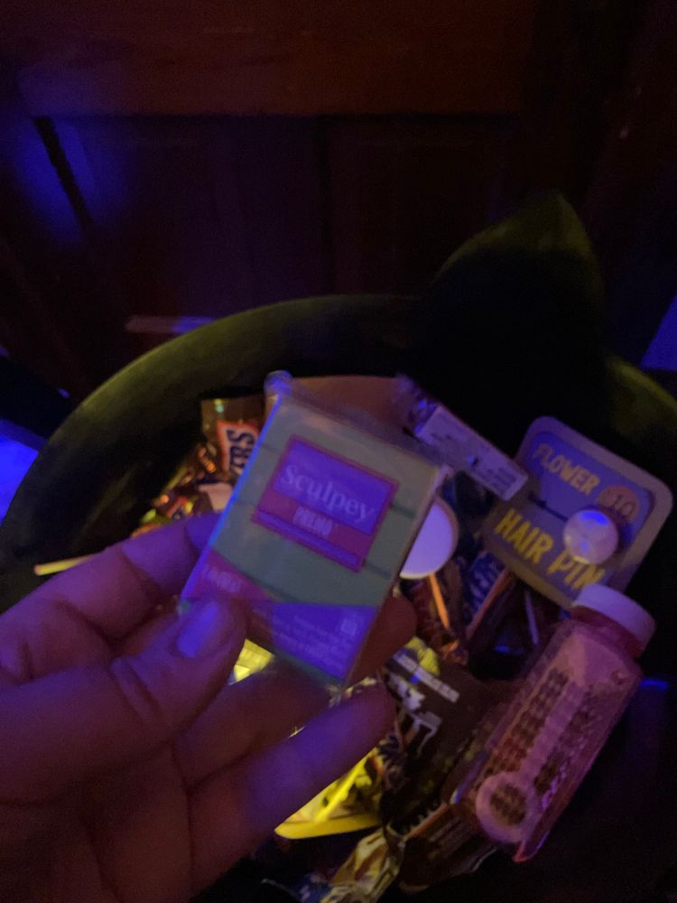 sculpey clay held up over a candy bowl with various items