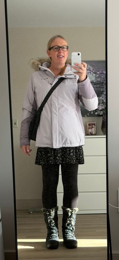 Annaa dressed in her new purple Columbia ski jacket and tall black winter boots. 