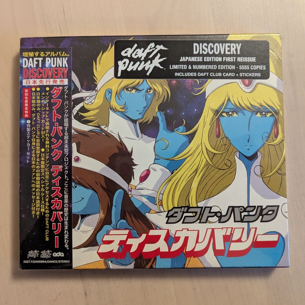 Front of the Daft Punk Discovery Japanese Edition CD case. In the top-right corner is a sticker saying "Discovery - Japanese Edition First Reissue - Limited & Numbered Edition - 5555 Copies - Includes Daft Club Card + Stickers"