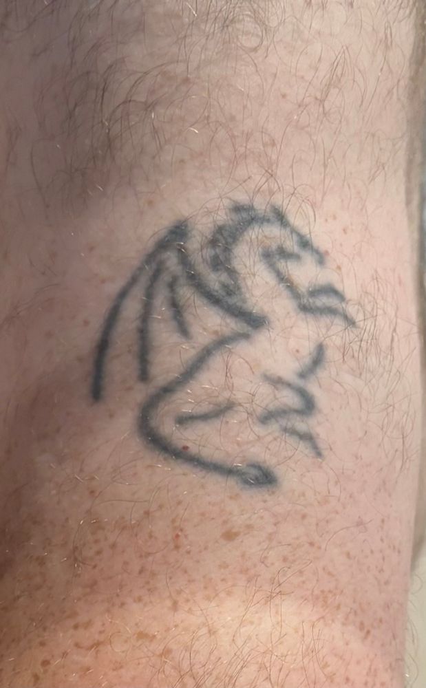 Another dragon tattoo. This one is stylised, not unlike a chalk hill figure, tattooed in black. This was designed for me by a friend.