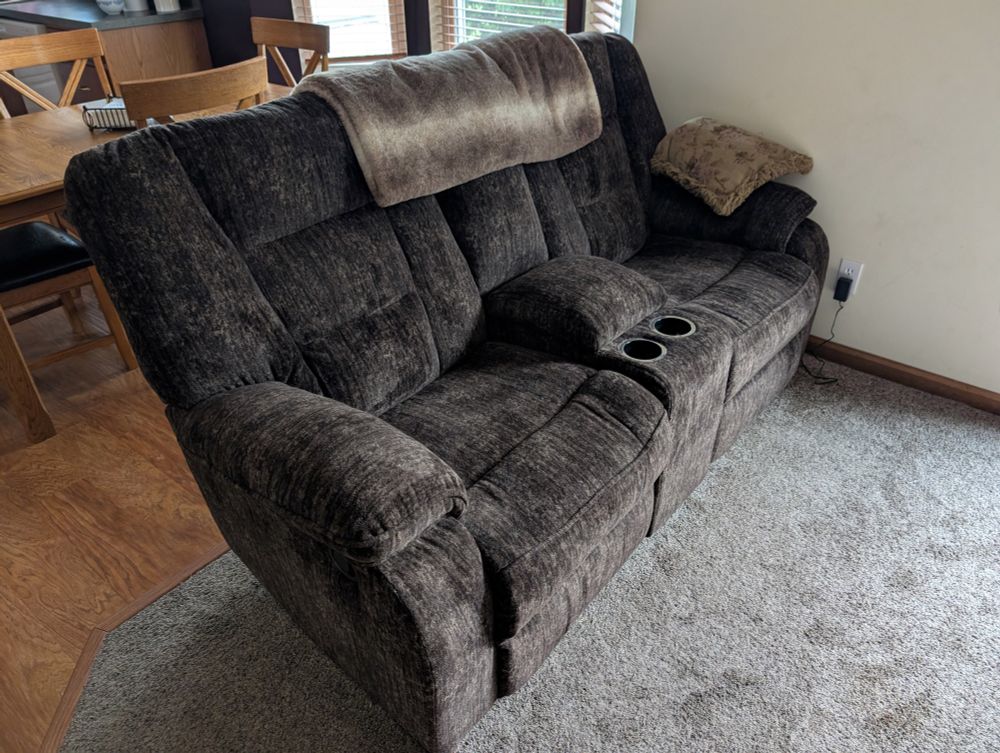 A brownish-gray (sable? Maybe) loveseat recliner, probably from La-Z-Boy. 