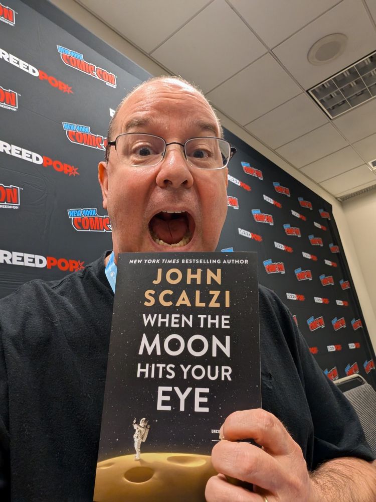 Me with an ARC of When the Moon Hits Your Eye