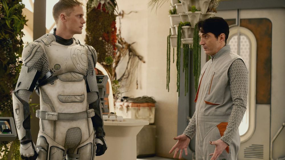 Alexander Skarsgård and David Dastmalchian, in a scene from Murderbot, looking at each other awkwardly. 