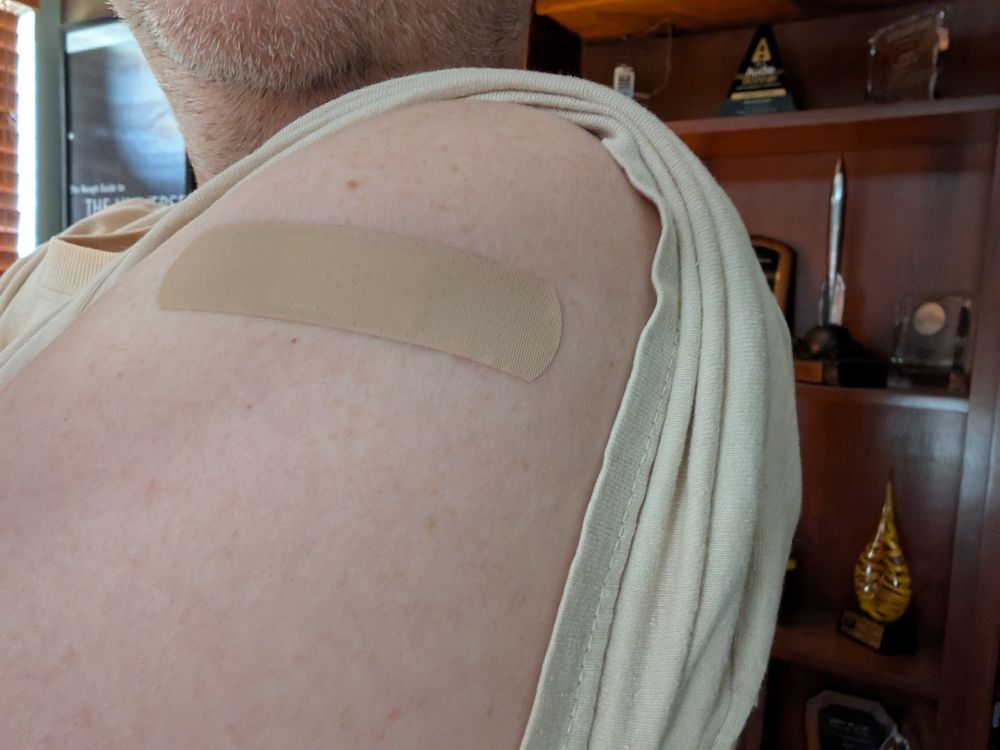 My arm, with bandaid hiding my injection site.