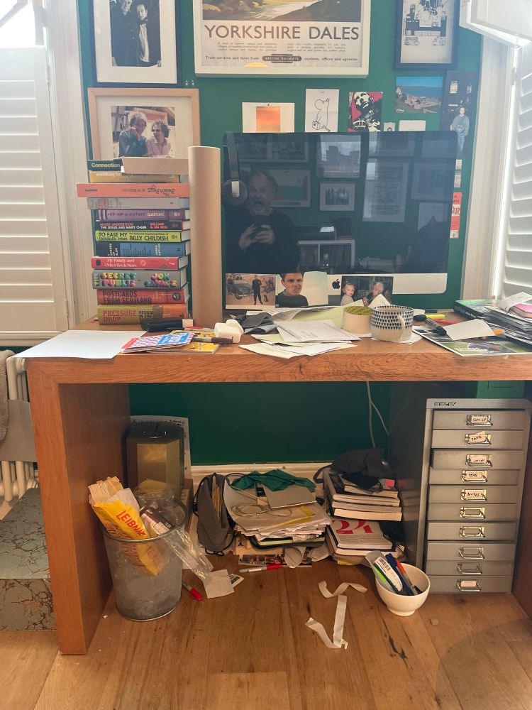 Very messy desk and books and papers 