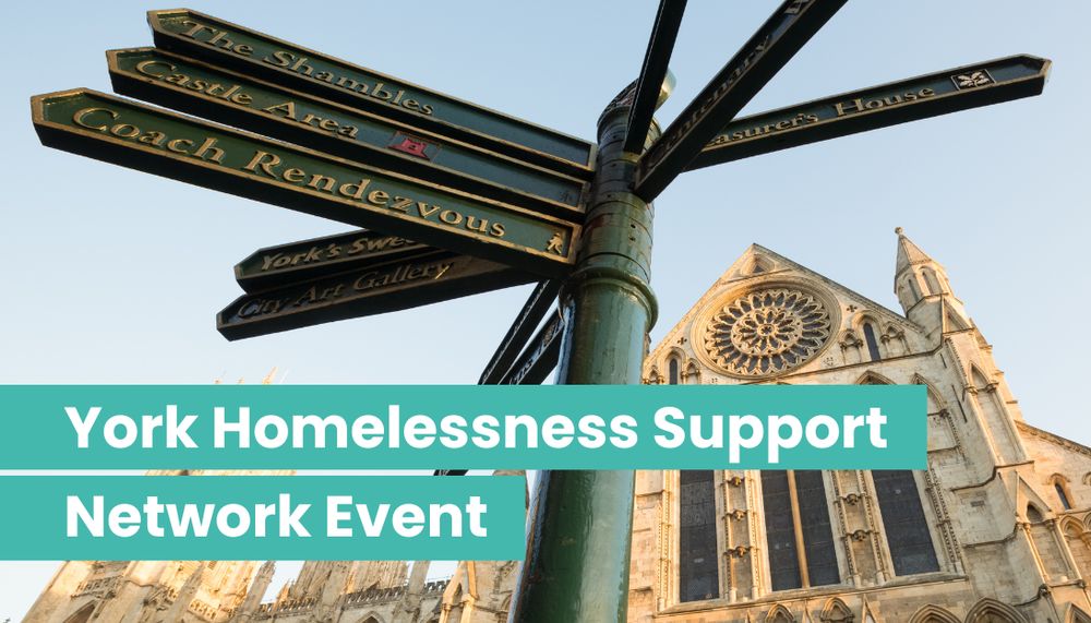 Close-up of a green directional signpost in York pointing to local landmarks with York Minster in the background under clear sky.