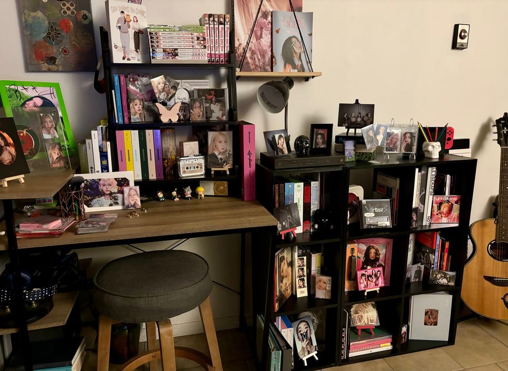 Photo of a desk and cube shelves with kpop albums and inclusions displayed 