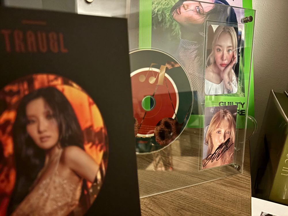image of acrylic display stand with travel album disc and two photocards  