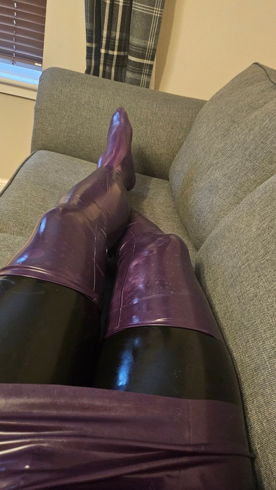 Me lounging on the sofa with my purple dress over a black catsuit with additional purple stockings