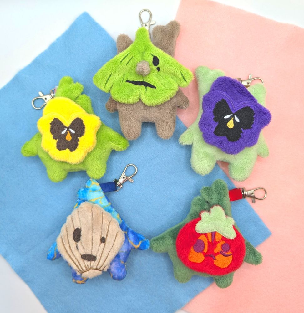 A collection of handmade Summer themed Korok plushie keychains from the Legend of Zelda.