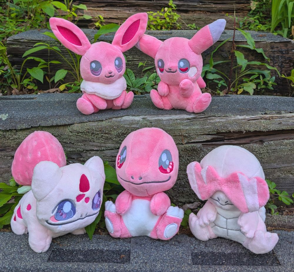A collection of handmade pink Pokemon plushies.