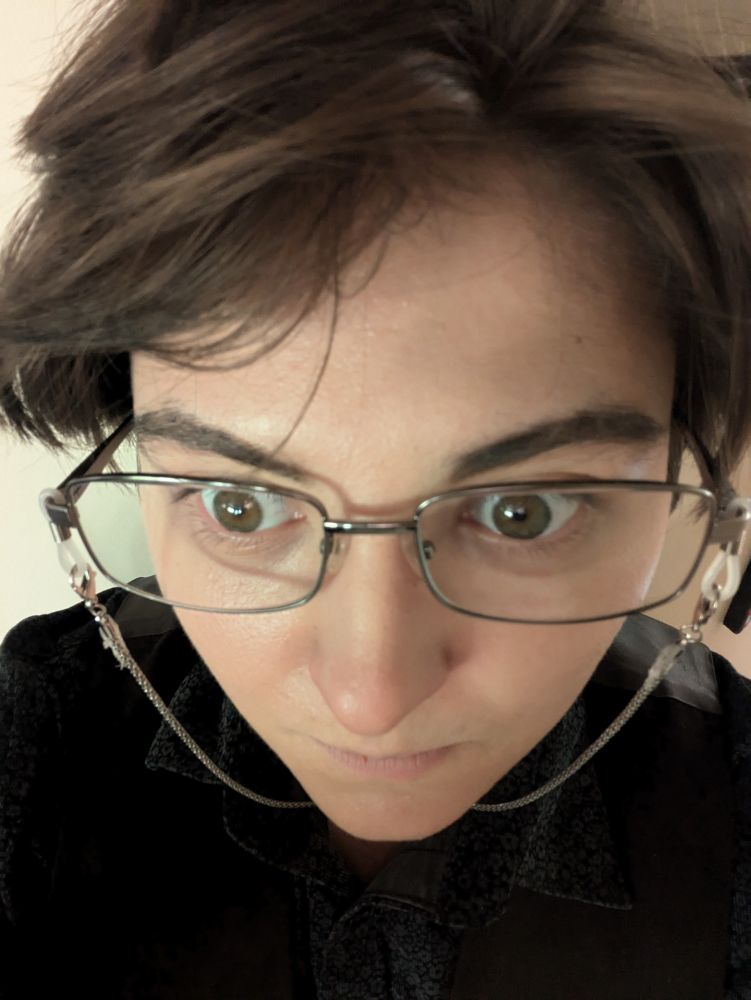 Endicott in the Edwin costume with a tight zoom on their face with wide, haunted eyes